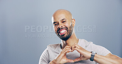 Buy stock photo Love emoji, heart hands and portrait of man for support with charity or health isolated on gray background. Mockup space, smile and sign for care, romance or wellness with symbol or shape in studio