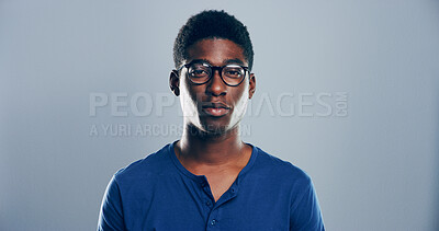 Buy stock photo Smart, student or portrait of black man in studio for skill development, college education or learning. Face, nerd and African person with glasses on grey background mockup for school scholarship