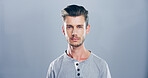 Confident, serious and portrait of man, fashion and graphic designer with casual outfit and studio. Mockup space, blue background and person with creative career, calm and stylish with clothes in USA