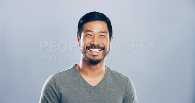 Buy stock photo Asian man, happy and studio portrait with creative employee, pride and confident for freelance career. Writer, freelancer or author with professional headshot by mockup space on blue background