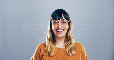 Buy stock photo Portrait, laugh and creative woman in studio, comedy screenwriter or script author with glasses. Face, funny and happy business person, professional or confidence with space on gray background in Uk