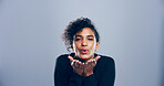 Love, woman and blowing kiss in studio, portrait and gesture for romance for valentines day or space. Blue background, mockup and black person with expression for flirting, happy and girl with pout