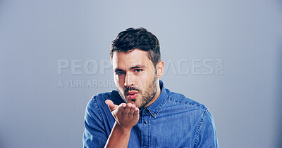 Buy stock photo Portrait, man or blowing with kiss for romance, affection or love on a gray studio background. Creative, male person or model with romantic gesture or palm for care, distance or flirt on mockup space