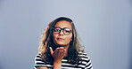 Creative, woman or blowing with kiss for love, affection or romance on a gray studio background. Female person, glasses or model with romantic gesture or symbol of distant interaction on mockup space