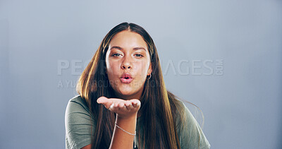 Buy stock photo Portrait, woman and blowing kiss with romance for love, affection or greeting on a gray studio background. Creative, female person or model with care, palm or flirt in distance on mockup space
