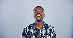 Black man, portrait and laughing for success in studio, joy for opportunity in creative career or promotion. Happy, space and male person excited with comic illustrator or designer on blue background