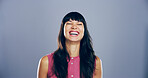 Humor, woman and happy for laugh in studio with confidence, joke and good mood on gray background. Space, young model and smile with carefree personality for comedy, joy or funny reaction to meme