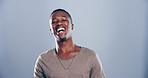 Face, black man and happy for laugh in studio with confidence, joke and good mood on gray background. Space, model and smile with carefree personality for comedy, humor or funny reaction to meme