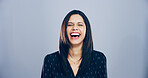 Crazy, woman and happy for laugh in studio with confidence, joke and good mood on gray background. Space, young model and smile with carefree personality for comedy, humor or funny reaction to meme