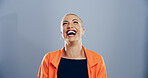 Crazy, woman and happy for laugh in studio with confidence, joke and good mood on gray background. Space, excited model and smile with carefree personality for comedy, humor or funny reaction to meme