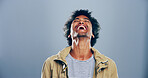 Crazy, African man and happy for laugh in studio with confidence, joke and good mood on gray background. Space, model and smile with carefree personality for comedy, humor or funny reaction to meme