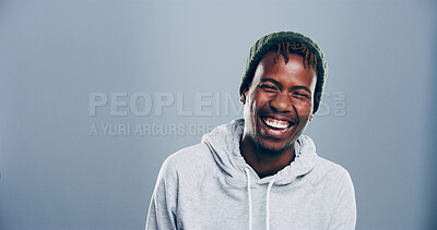 Buy stock photo Happy, black man and laughing in studio for funny joke, comedy or goofy with mockup space. Face, portrait and African person with humor, excited and lol with comic emotion isolated on gray background