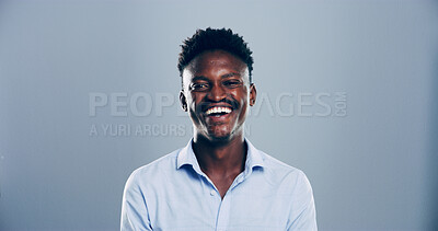 Buy stock photo Portrait, black man and happy for laugh in studio with confidence, joke and good mood on gray background. Space, model and smile with carefree personality for comedy, humor or funny reaction to meme