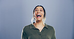 Comic, woman and face for laugh in studio with confidence, joke and good mood on gray background. Space, excited model and smile with carefree personality for comedy, humor or funny reaction to meme