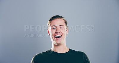Buy stock photo Portrait, man and happy in studio for funny joke, crazy comedy and smile isolated on gray background with space. Face, LOL and male person with humor, excited and laughing with comic emotion in USA