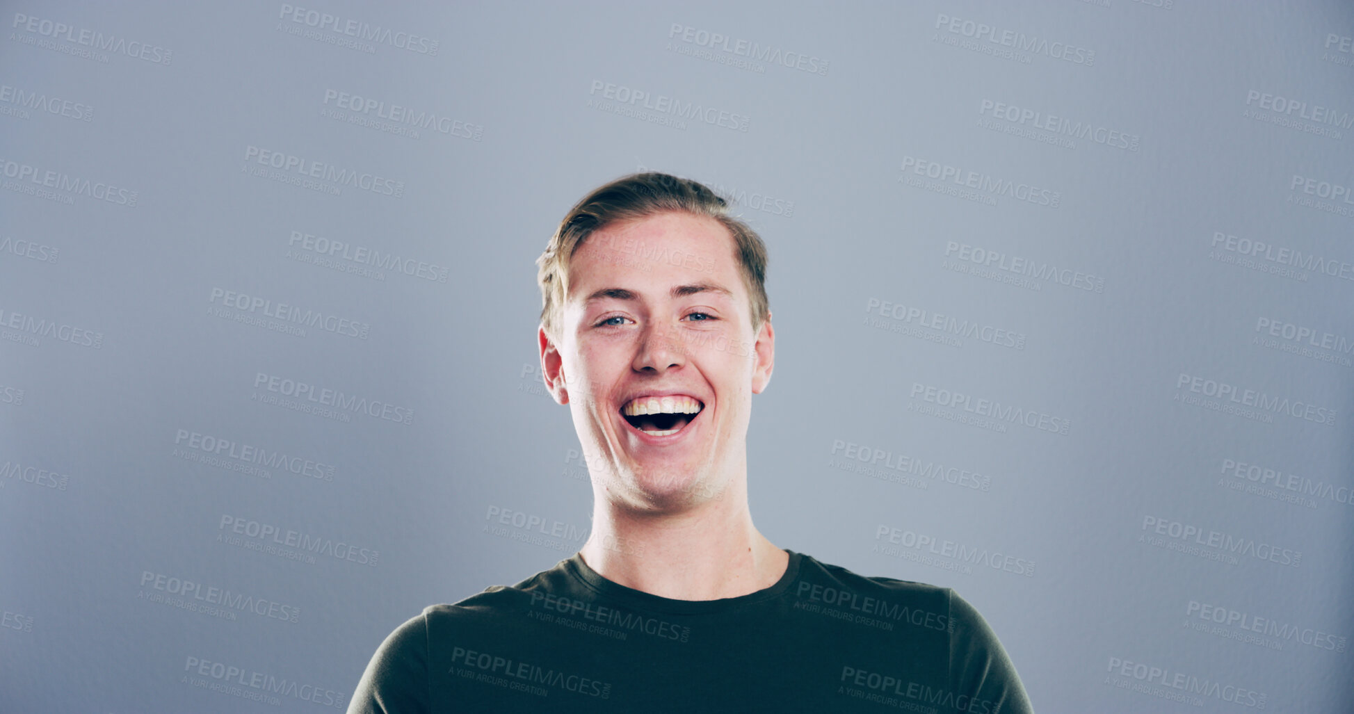 Buy stock photo Portrait, man and happy in studio for funny joke, crazy comedy and smile isolated on gray background with space. Face, LOL and male person with humor, excited and laughing with comic emotion in USA