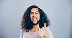 Space, wild or portrait of man with rock hand gesture in studio for expression on gray background. Culture, edgy male rocker and crazy person with devil horn sign, funky emoji and cool punk symbol