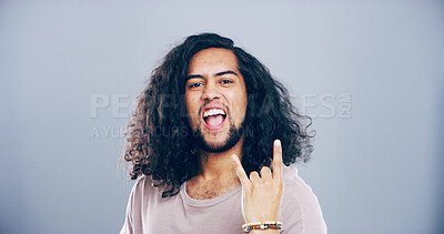Buy stock photo Space, wild or portrait of man with rock hand gesture in studio for expression on gray background. Culture, edgy male rocker and crazy person with devil horn sign, funky emoji and cool punk symbol
