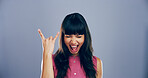 Space, screaming and girl with rock hand gesture in studio for expression or mockup on gray background. Culture, edgy female rocker and crazy woman with devil horn sign, funky emoji and punk symbol