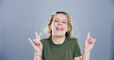 Buy stock photo Portrait, smile and girl with rock hand gesture in studio for expression or space on gray background. Culture, edgy female rocker and crazy woman with devil horn sign, funky emoji and punk symbol