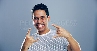 Buy stock photo Studio, happy or portrait of Indian man with rock hand gesture, confidence or expression on gray background. Culture, edgy rocker and crazy person with devil horn sign, funky emoji and punk symbol