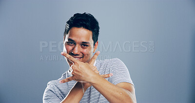 Buy stock photo Studio, cool or portrait of Indian man with rock hand gesture, confidence or crazy expression on gray background. Culture, edgy rocker or happy person with devil horn sign, funky space or punk symbol