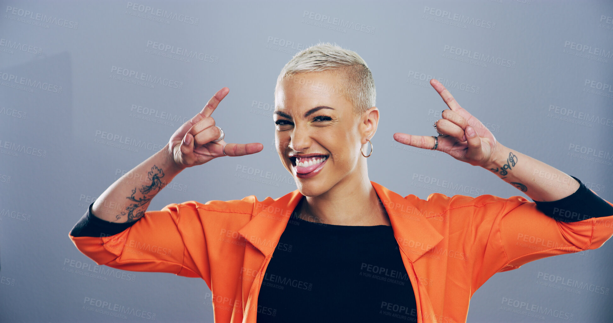 Buy stock photo Portrait, edgy or happy woman with rock hand gesture in studio for expression or space on gray background. Culture, cool female rocker and crazy model with devil horn sign, funky emoji or punk symbol
