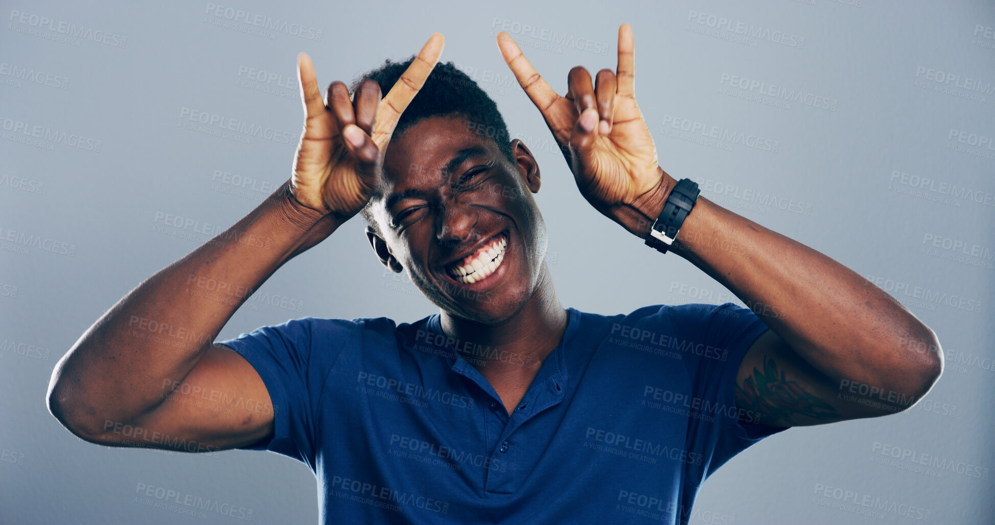 Buy stock photo Space, happy or portrait of black man with rock hand gesture in studio for wild expression on gray background. Crazy, edgy rocker and African person with devil horn sign, funky emoji and punk symbol