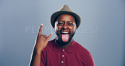 Buy stock photo Crazy, happy or portrait of black man with rock hand gesture or tongue out in studio on gray background. Space, edgy rocker and African person with devil horn sign, funky emoji and wild punk symbol