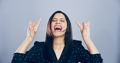 Buy stock photo Crazy, screaming and woman with rock hand gesture in studio for expression or space on gray background. Culture, edgy female rocker and wild model with devil horn sign, funky emoji and punk symbol