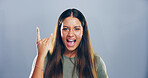 Rock, emoji and portrait of woman in studio with hand gesture for crazy, heavy metal and edgy attitude. Mockup space, rebel and person with punk sign, symbol and devil horns on gray background