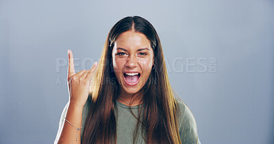Buy stock photo Rock, emoji and portrait of woman in studio with hand gesture for crazy, heavy metal and edgy attitude. Mockup space, rebel and person with punk sign, symbol and devil horns on gray background