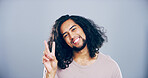 Portrait, happy and Indian man with peace sign in studio with positive attitude, confidence or facial expression. Grey background, casual and proud male model for cool gesture, review or v symbol