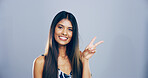 Portrait, peace sign and woman in studio, smile and confidence on blue background. Face, person and model with hand gesture, support and agreement with symbol, good vibes and emoji with icon