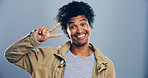 Portrait, smile and Indian man with peace sign in studio with positive attitude, confidence or facial expression. Grey background, casual and happy male model for cool gesture, review or v symbol 