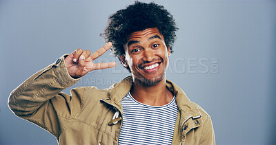 Buy stock photo Portrait, smile and man with peace sign in studio with positive attitude, confidence or facial expression. Grey background, casual and happy male model for cool gesture, review or v symbol with space