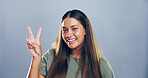 Portrait, peace sign and woman in studio, joy and confidence on gray background. Face, person and model with hand gesture, support and agreement with symbol, good vibes and emoji with icon or smile