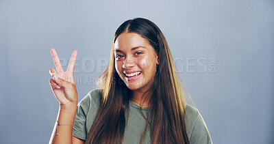 Buy stock photo Portrait, peace sign and woman in studio, joy and confidence on gray background. Face, person and model with hand gesture, support and agreement with symbol, good vibes and emoji with icon or smile