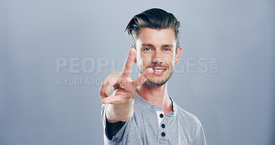 Buy stock photo Portrait, space and happy man with peace sign, confidence or positive attitude for expression. Grey background, casual student and proud male model in studio for cool gesture, fashion or v symbol