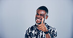 Happy, black man or portrait with thumbs up for success, winning or approval on a gray studio background. Face, male person or model with smile, like emoji or yes sign for good job on mockup space