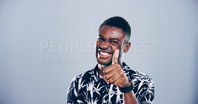 Buy stock photo Happy, black man or portrait with thumbs up for success, winning or approval on a gray studio background. Face, male person or model with smile, like emoji or yes sign for good job on mockup space