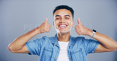 Buy stock photo Man, portrait and smile with thumbs up in studio for winning success, poll agreement and satisfaction. Space, person and happy feedback with yes gesture for positive review or like on blue background