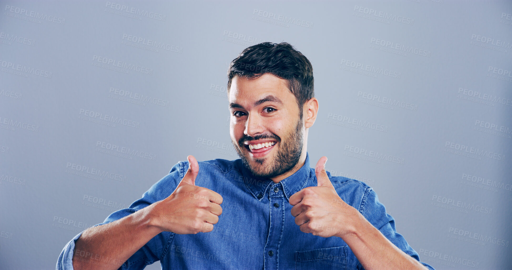 Buy stock photo Man, portrait and excited with thumbs up in studio for vote approval, poll agreement and support. Mockup, person and happy feedback with like gesture for positive review or praise on gray background