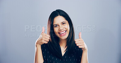 Buy stock photo Woman, portrait and positive with thumbs up in studio for vote motivation, poll agreement and support. Mockup, person and happy feedback with like gesture for achievement or praise on gray background