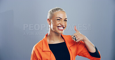 Buy stock photo Portrait, thumbs up and woman with symbol, feedback and confidence on gray studio background. Face, person and model with gesture, agreement and icon with review, perfect and like with emoji or great