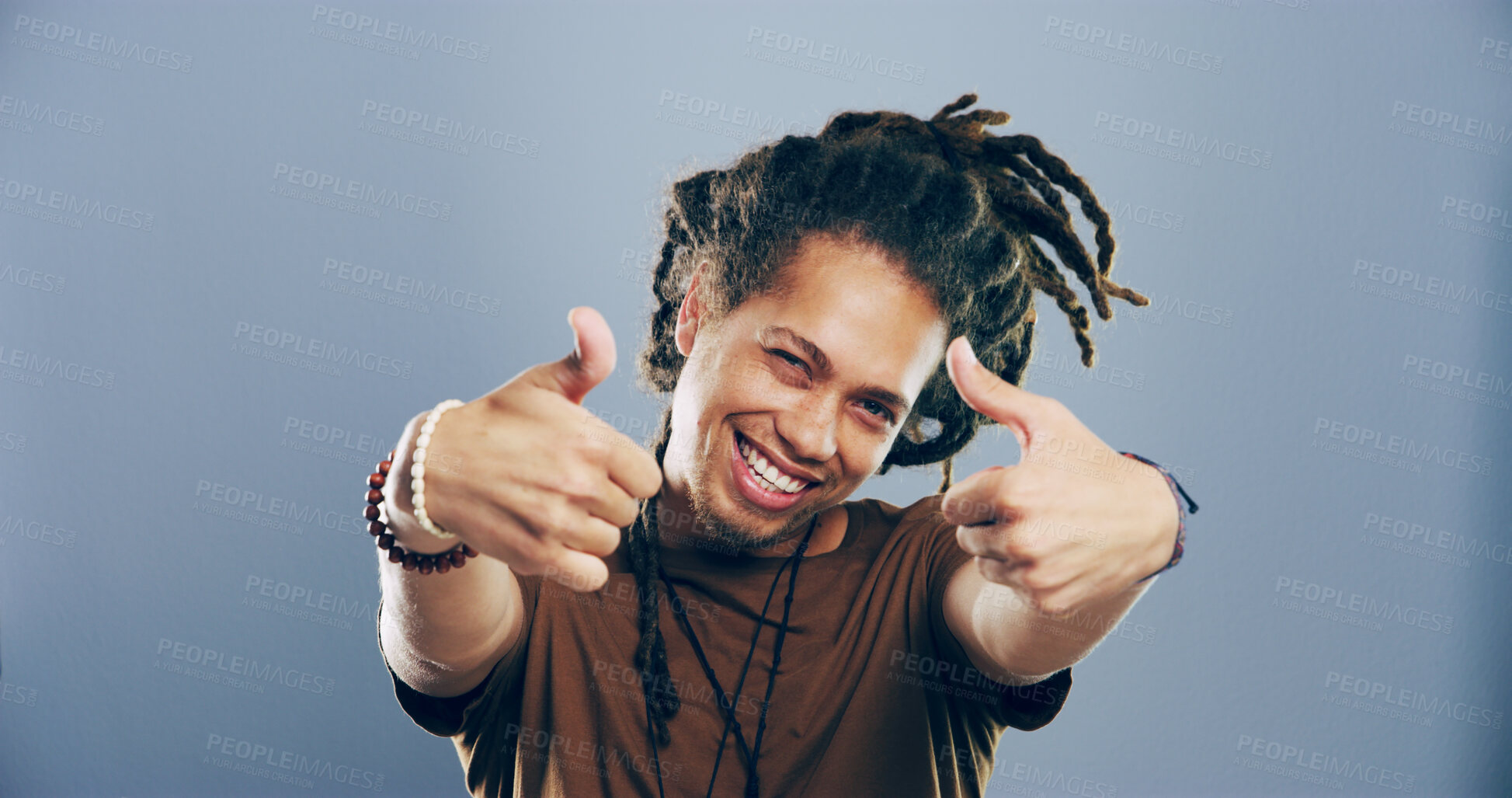 Buy stock photo Portrait, thumbs up and man in studio, like and confidence on gray background. Face, happy person and model with hand gesture, agreement or icon with symbol, perfect and review with emoji or feedback