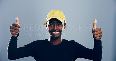Buy stock photo Happy, black man or portrait with thumbs up for well done, success or winning on a gray studio background. Face, male person or model with smile, like emoji or yes sign for approval on mockup space