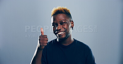 Buy stock photo Happy, black man or portrait with thumbs up for success or positive feedback on a gray studio background. Face, male person or model with smile, like emoji or yes sign for approval on mockup space