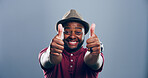 Happy, black man or portrait with thumbs up for approval, success or good job on a gray studio background. Face, male person or model with smile, like emoji or yes sign for winning on mockup space