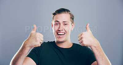 Buy stock photo Happy man, portrait and success with thumbs up for approval or good job on a gray studio background. Face, male person or model in joy with smile, like emoji or yes sign for winning or thank you